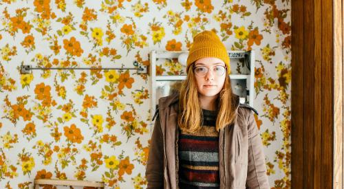 Woman standing in bathroom with '70s décor