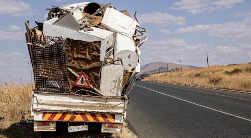 Truck overloaded with garbage from construction site