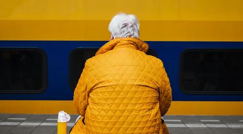 Senior man sitting at train station