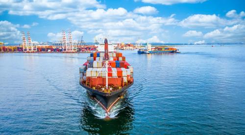 Ship loaded with shipping containers leaving port