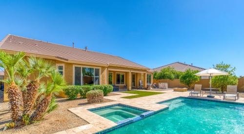 Backyard pool behind small luxury home