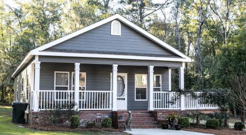 Small A-frame home with gray siding and white trim