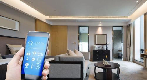 hand holding smartphone in a smart home