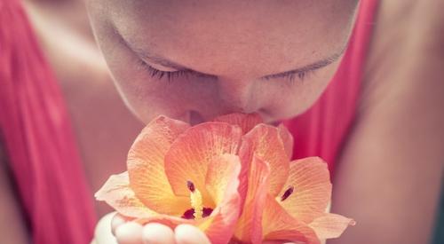 Woman_smelling_flower