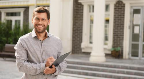 Smiling Realtor in front of home