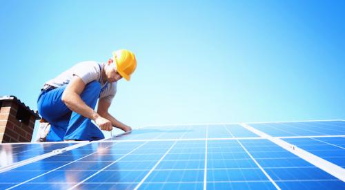 Solar panels being installed on roof on a sunny day