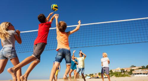 Boys spiking a volleyball