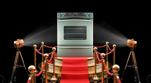 Silver stove range on pedestal in spotlight on red carpet 