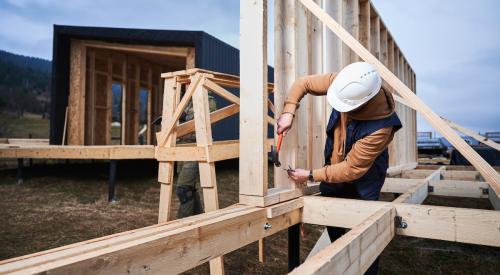 Student working on house frame