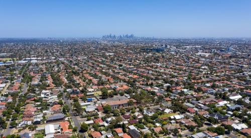 Suburb backdropped by city skyline