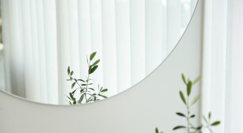 Blinds reflected in a mirror in a home