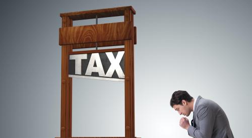 Man kneeling beside tax guillotine 