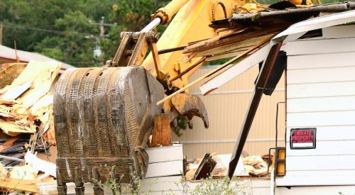 Crane tearing down existing house to build a new home