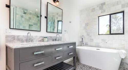 White tiled bathroom with bathtub