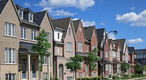 Modern red brick townhouses on residential street