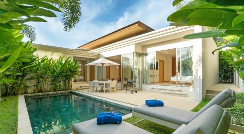 Outdoor pool in backyard of tropical vacation home