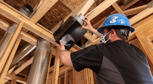 Ventilation fan being installed in ceiling