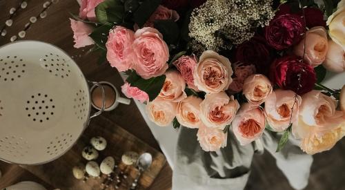 Table with cooking utensils and flowers