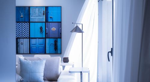 House interior with lamp sofa and blue wall hanging