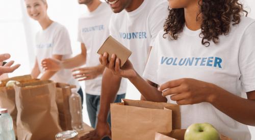 Volunteers packing bags at a food bank