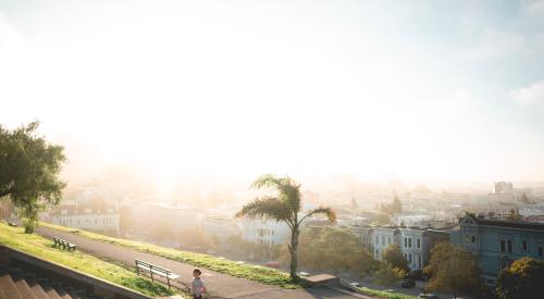 San Francisco homes and person running up steps in the morning