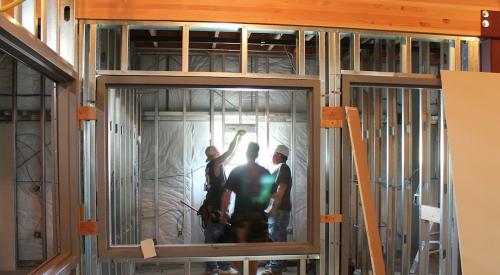 Framers installing a window