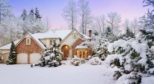 Winter home in the evening with outdoor lighting