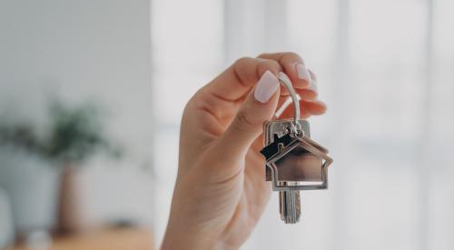 Woman holding silver house keys