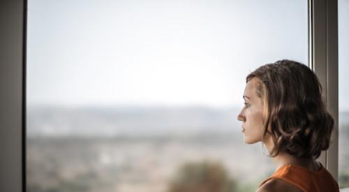 potential homebuyer looking forlornly out the window as the housing market slows