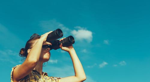 Woman searching with binoculars