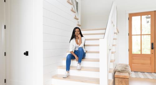 Woman sitting on the stairs in suburban home