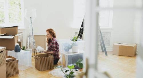 Woman unpacking a box in her new home