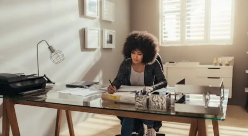 Woman working at desk in home office