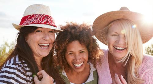 Women smiling into camera outdoors