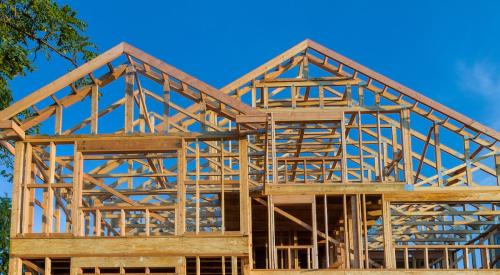 Wood framed house against blue sky