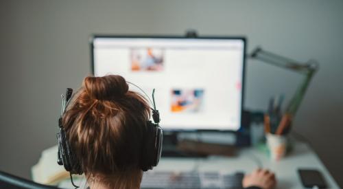 Woman working at computer in house