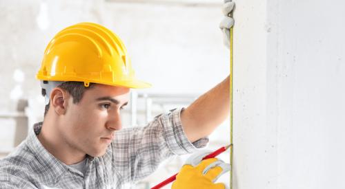 Young Builder working on a wall